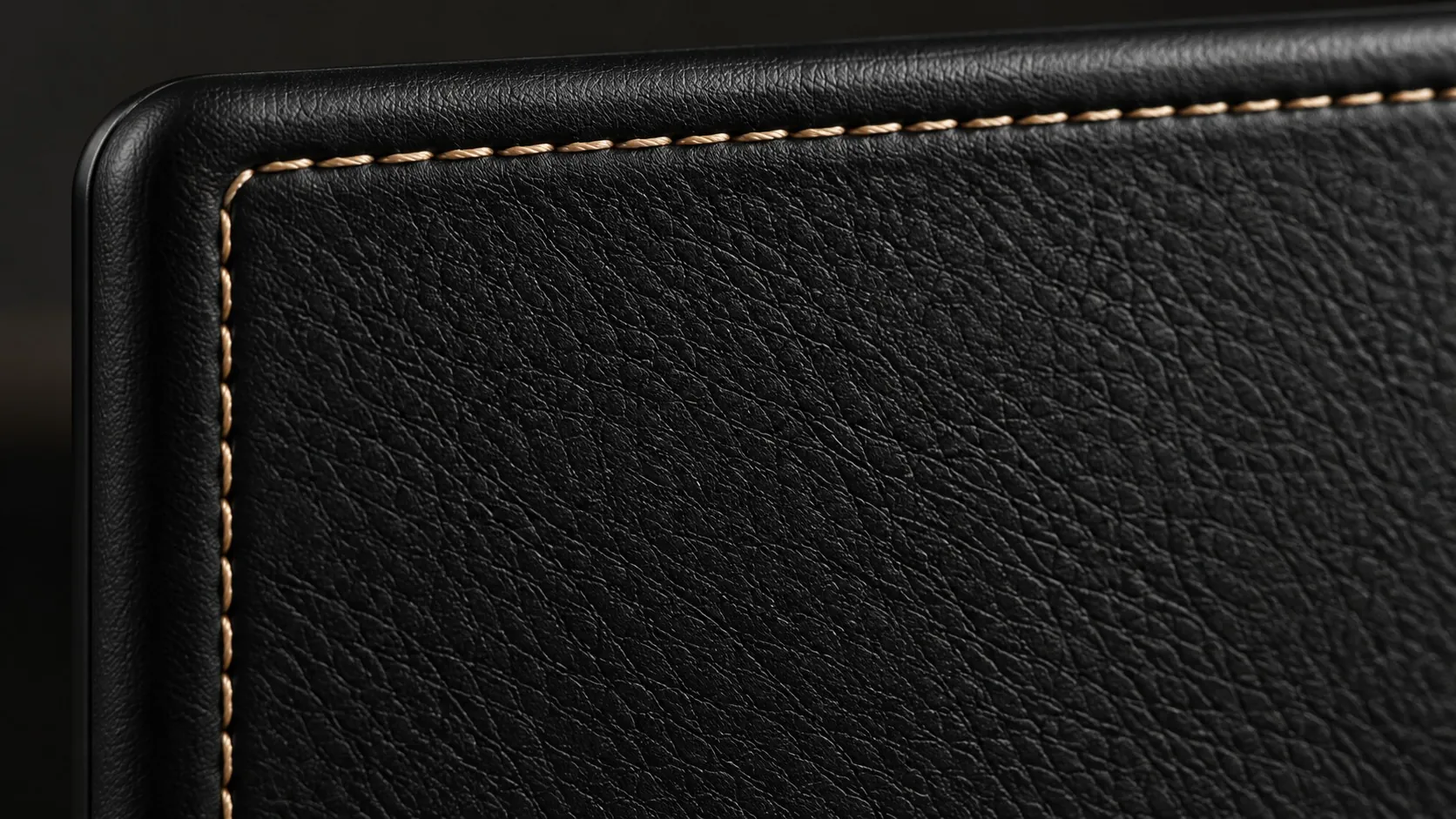 Black leather corner with the fine gold stitching of the plugin enclosure